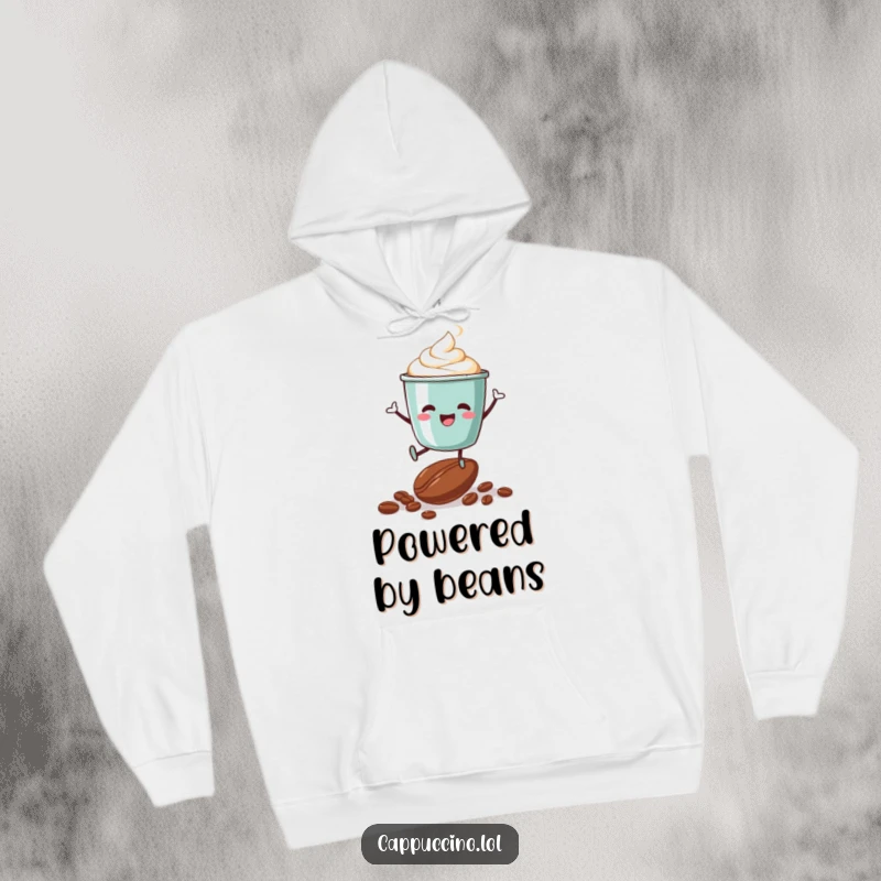 Funny hoodie showcasing an ecstatic cappuccino cup character mid-jump over a scattering of coffee beans, capturing energetic vibes.
